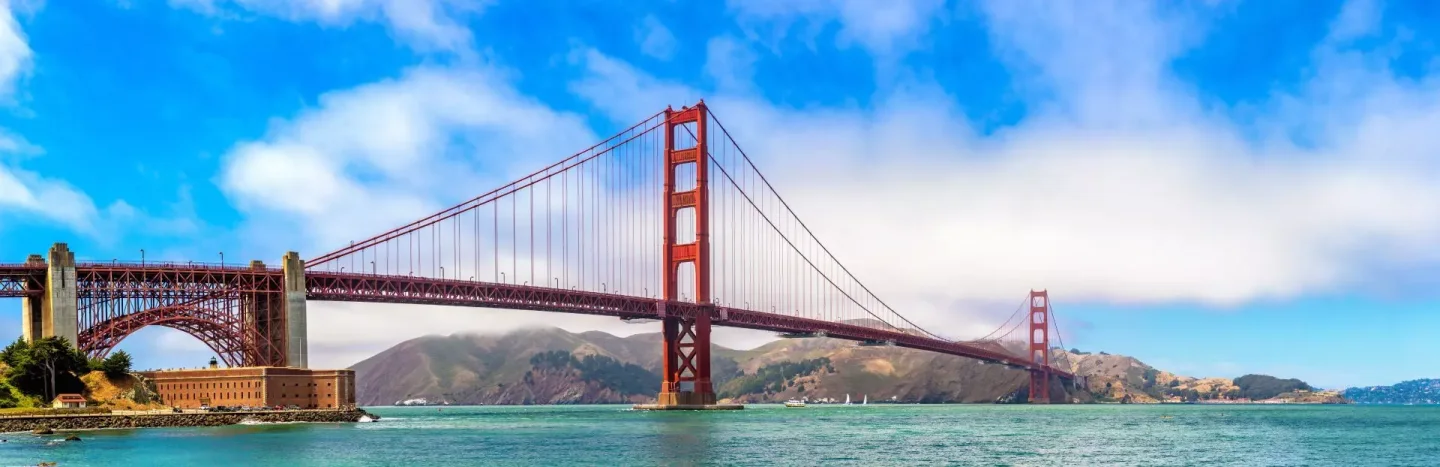 The complete Golden Gate Bridge span and both towers, with the Marin Headlands behind it